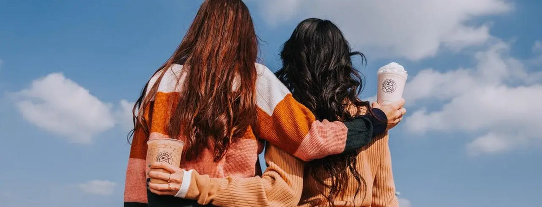 Two Women Holding Coffee Drinks