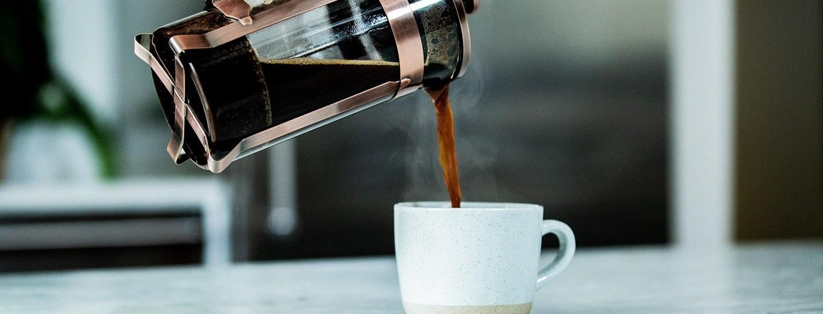 Person Pouring Coffee into mug
