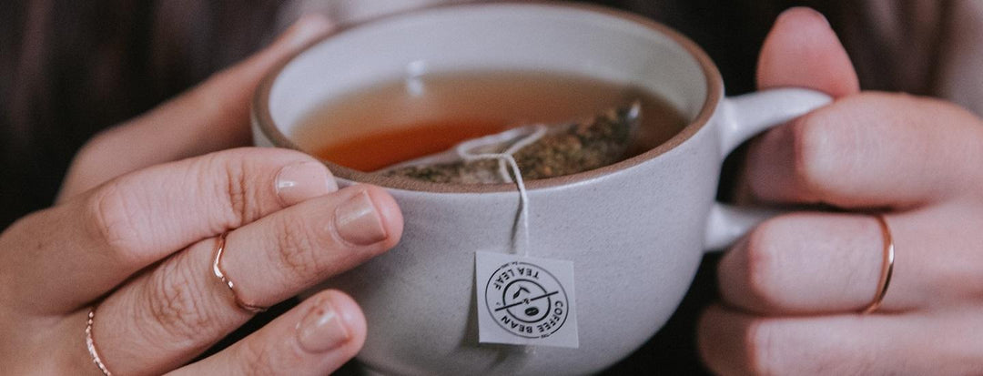 Person Holding Tea Cup