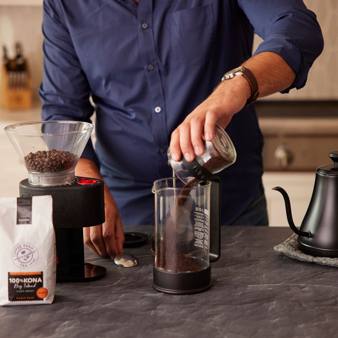 Man adding coffee grounds to a french press