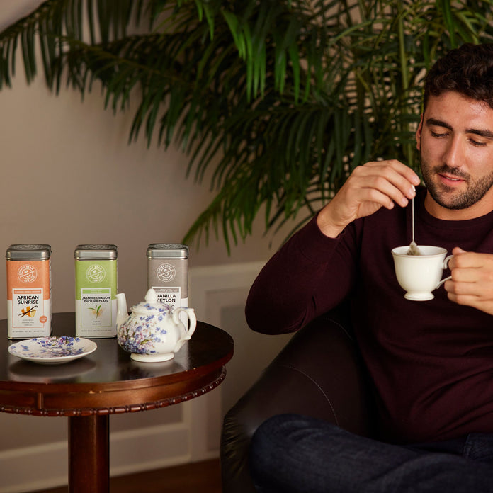 Man drinking tea with tea on the table